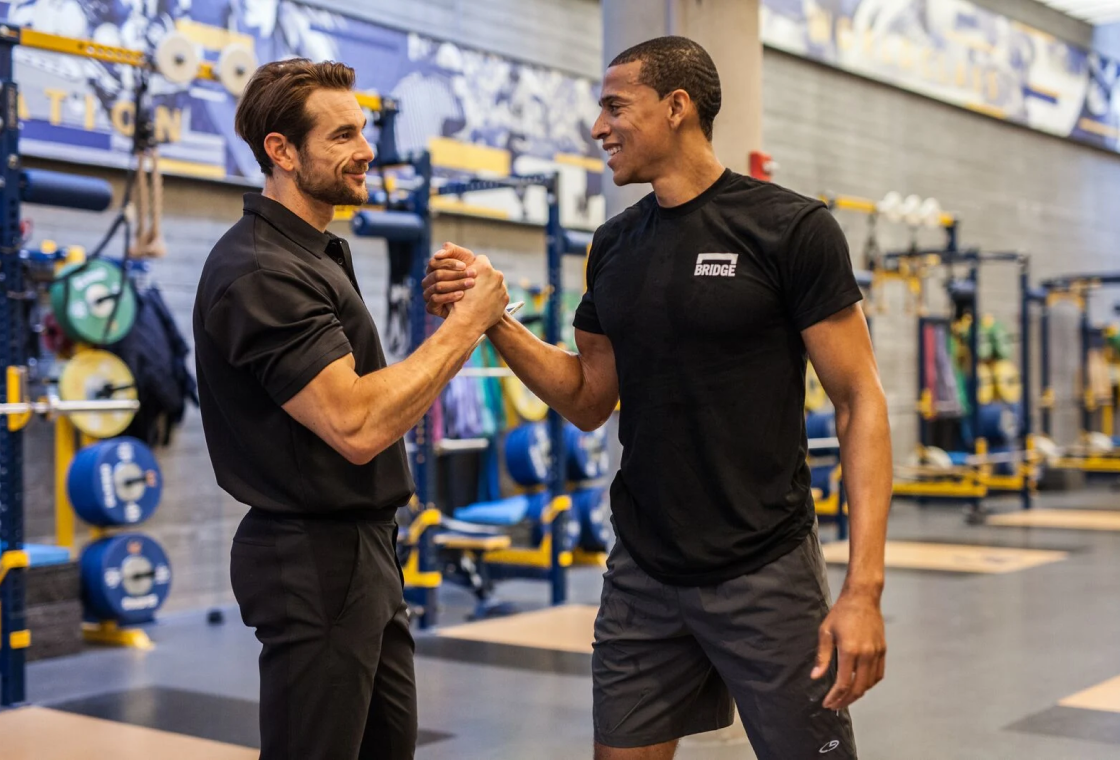 BridgeAthletic coaches and athlete in a training facility